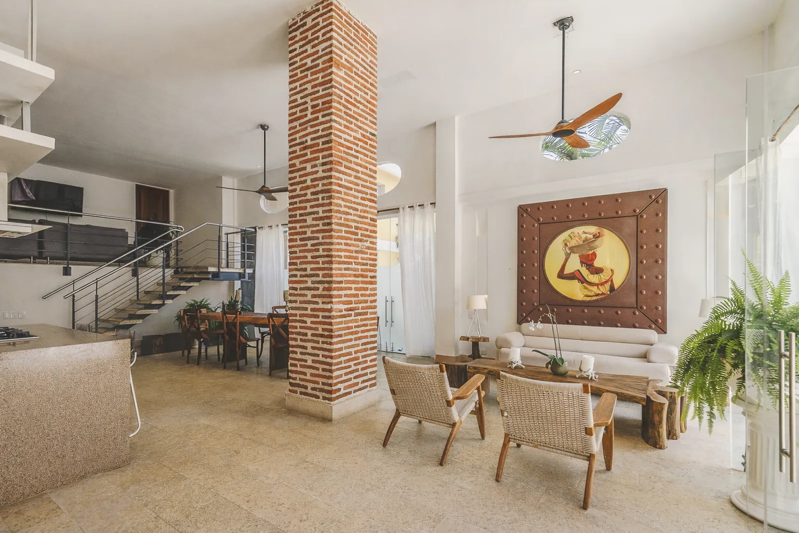 Living and dining area with exposed brick walls and 4 m ceilings