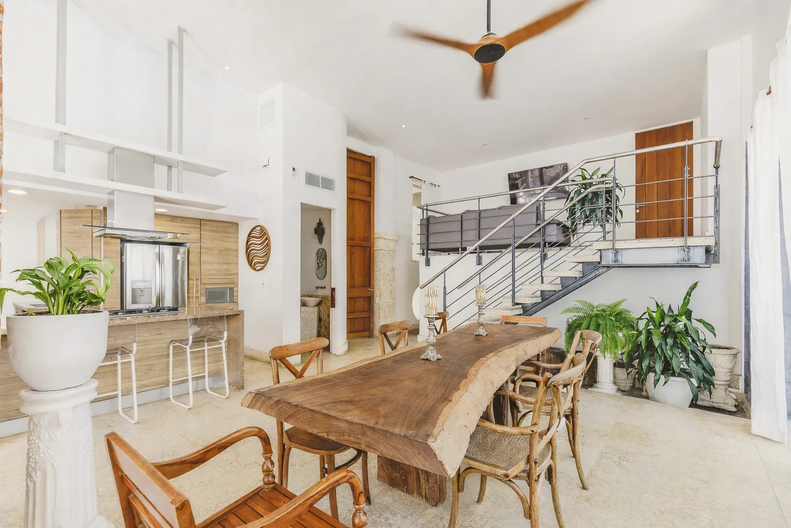 Dining area and designer staircase of the apartment
